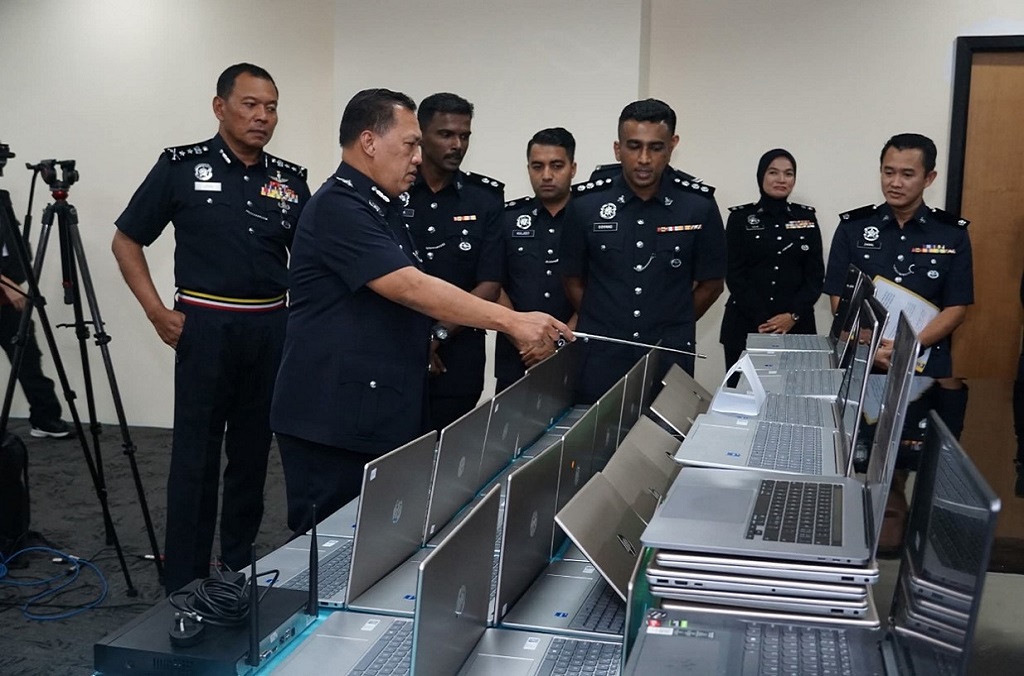 Photo 7 - Authorities in Malaysia confiscated dozens of laptops linked to a scam syndicate. .jpg