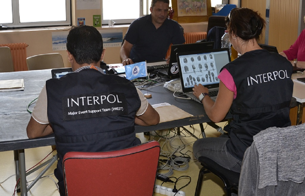 INTERPOL officers cross-check fingerprints during the G7 Summit in France.