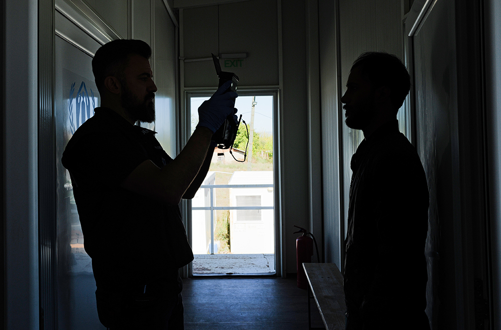 15_An officer collects biometric data at a migrant centre.JPG